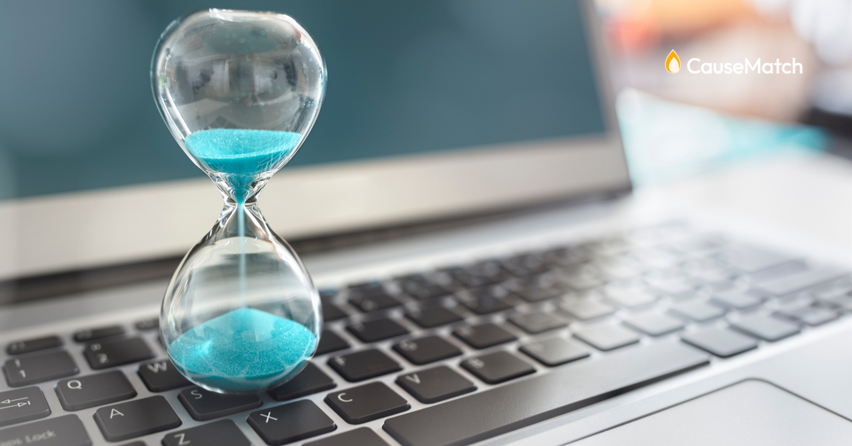 Sand clock running out of time on a computer keyboard