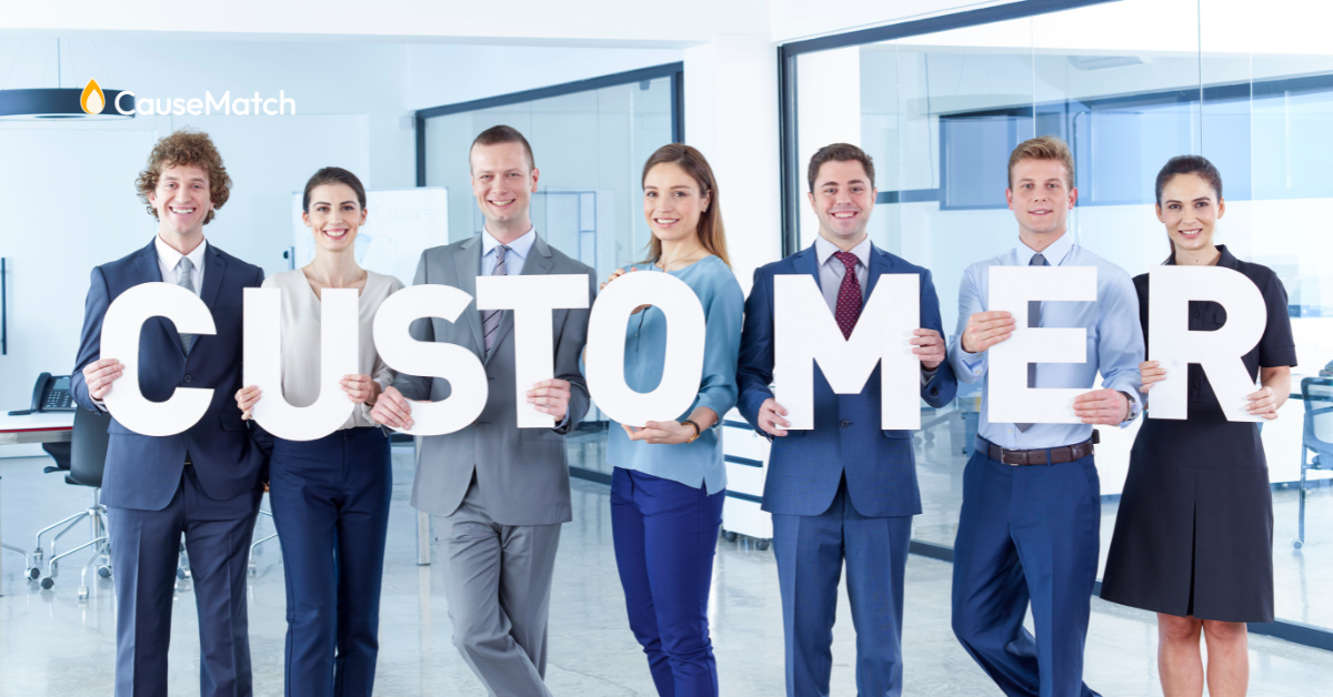 employees holding up the word "Customers: